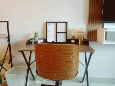 a wooden table with a chair in a room at Luxe Bonifacio Global City Taguig Uptown Condo Hotel 1 BR Suite in Manila
