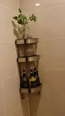 a shelf in a bathroom with a potted plant at Luxe Bonifacio Global City Taguig Uptown Condo Hotel 1 BR Suite in Manila