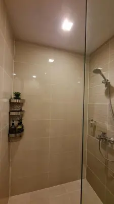 a shower with a glass door in a bathroom at Luxe Bonifacio Global City Taguig Uptown Condo Hotel 1 BR Suite in Manila