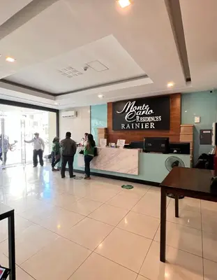 a group of people standing in a restaurant lobby at Staycation Condotel Room To Stay in Manila