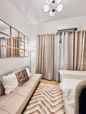 a living room with a couch and curtains at 9th Queen Size One Bedroom in Grace Residences, Taguig in Manila